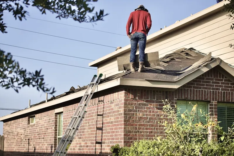 Professional roofer working on a residential roof in North Sea